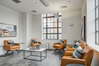 a living room with couches and chairs and a table